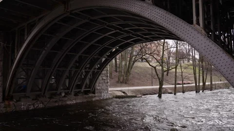 Slow motion shot of a river that runs under an old steel bridge 1 Stock Footage 273955464