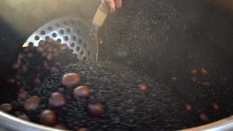 Slow motion shot of roasted chestnuts in an automatic machine .Street Food  Stock Footage 121047774