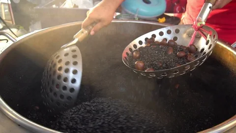 Slow motion shot of roasted chestnuts in an automatic machine .Street Food  Stock-Footage 121048014