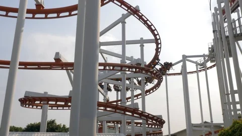 Slow motion shot of roller coaster train going down in a spiral while Video stock 101371337