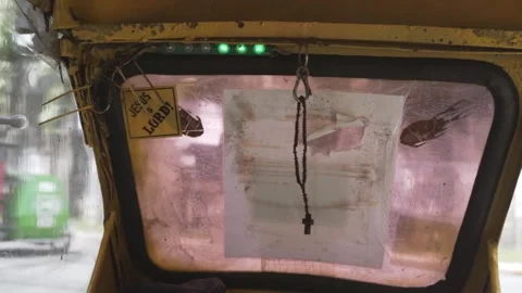 Slow Motion Shot of Rosary Bouncing Inside of a Vehicle Stock Footage 139791399