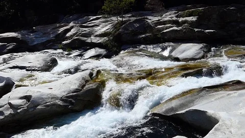Slow motion shot of a rushing mountain rocky river 動画素材 114178384