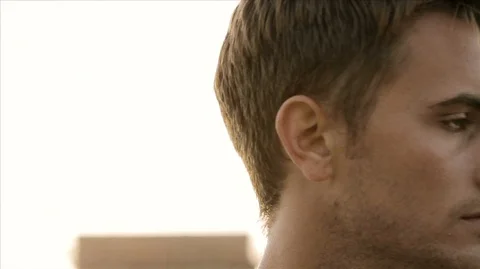Slow motion shot of serious man turning head to look at camera. 스톡 동영상 88406987