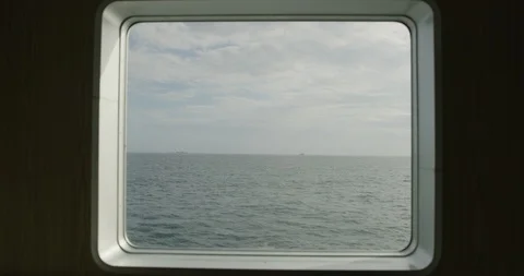 Slow motion shot from ship window on wavy blue sea and cloudy sky, Japan Stock Footage 124719760