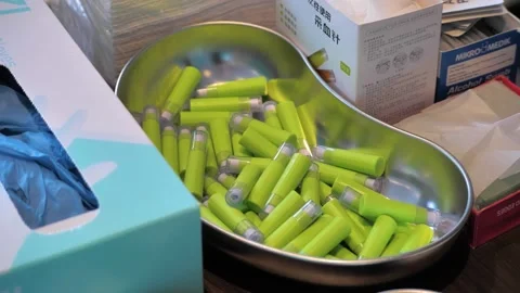 Slow motion shot of a silver kidney dish full of blood glucose monitoring Stock Footage 250067616
