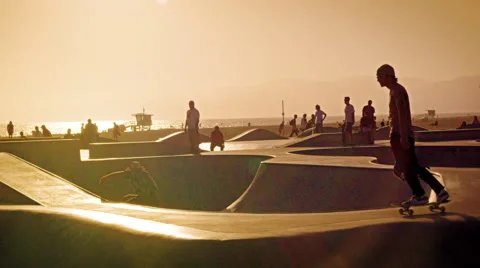 Slow motion shot of skateboarders and other people in a skate park near Venice Stock Footage