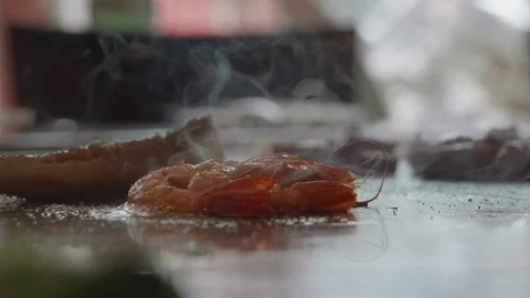 Slow motion shot of skilled teppanyaki chef cooking shrimp Stock Footage 88867799