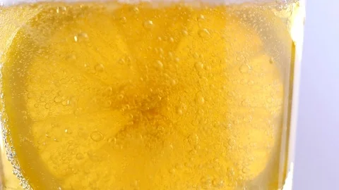 Slow motion shot of slice lemon in soda water. Stock Footage 126953269
