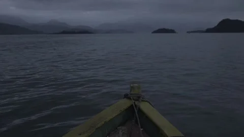 Slow Motion Shot of a Small Boat Moving Across Paraty Bay at Dawn Stock Footage 320634984