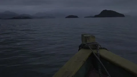 Slow Motion Shot of a Small Boat Moving Across Paraty Bay at Dawn Stock Footage 320634985
