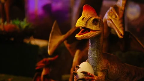 Slow motion shot of a small dinosaur holding its own eggs moving up and Stock Footage 236446499