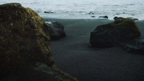 Slow motion shot of small rocks in Azores beach Stock Footage 111840063