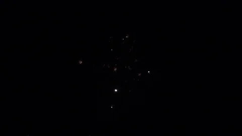 Slow motion shot of small sparkles of firework in black sky Stock Footage 79529380