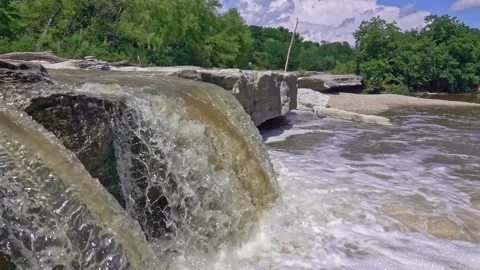 Slow motion shot of small waterfall flowing over rock Video stock 142401068