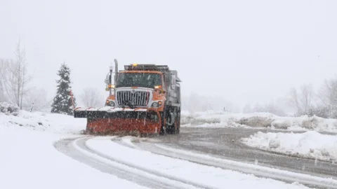 Slow motion shot of snowplow clearing snow of the roads after storm Stock Footage 112239404
