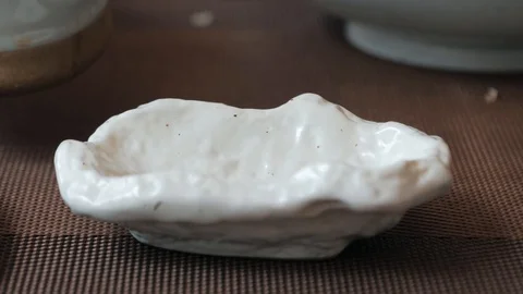 Slow motion shot of soy sauce pouring from a carafe Spice in Asian food Video stock 106492045