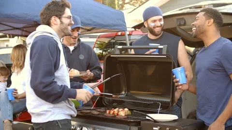 Slow Motion Shot Of Sports Fans Tailgating In Parking Lot Stock Footage
