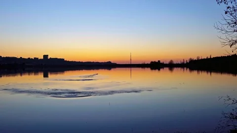 Slow motion shot of a stone skipping game during beautiful sunset Stock Footage 75232804