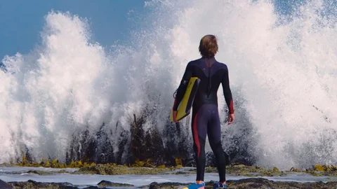 Slow motion shot of surfer with spectacular wave roaring up in front of him. Stock Footage 87250492
