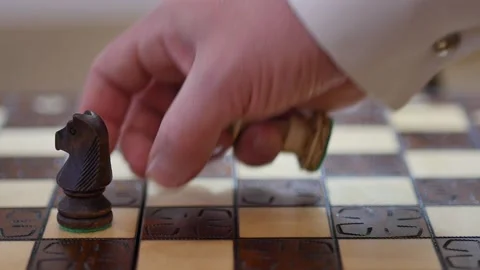 Slow motion shot of teacher setting exercise on chess board with knight and Stock Footage 146258014