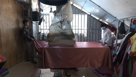 Slow motion shot of three workers with a large pressing machine handling a Stock Footage 118638527