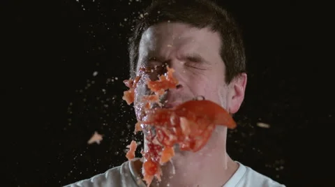 Slow motion shot of tomato hitting man in face, shot on Phantom Flex at 2000 fps Stock Footage 55666823