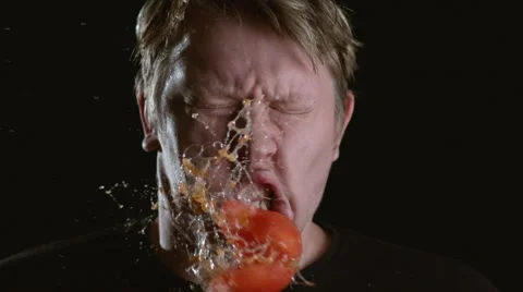 Slow motion shot of tomato hitting man in face, shot on Phantom Flex at 2000 fps Stock Footage 55666832