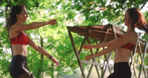 Slow motion shot, two beautiful women in sportswear meet and hug each other. Stock Footage 120235889