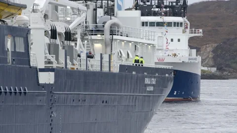 Slow motion shot of two crew members walking on the deck of a large Video stock 237595452