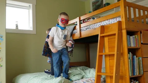 Slow motion shot of two cute boys in their capes playing super heros Video stock 86877554