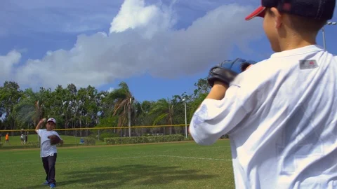 Slow motion shot of two kids throwing and catching during baseball practice Stock Footage 85648173