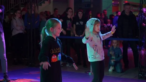 Slow motion shot of two little girls trying to repeat dancing moves from Video stock 157090900