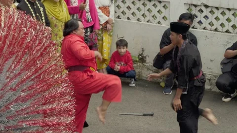 Slow-motion shot of two men performing Maen Pukul martial art from Betawi.  Stock Footage 314630937