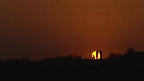 Slow motion shot of two person standing in front of sunset (3) Stock Footage 252120997