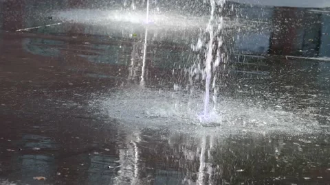 Slow-motion shot of two water fountains with purple light. Video stock 220607678