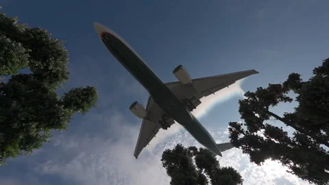 Slow motion shot underneath a large airliner leaving vapor trails arriving at Stock Footage 313257167