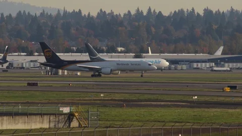 Slow motion shot of an UPS Cargo Boeing 757 taxiing to the runway for departure. Video stock 121344417