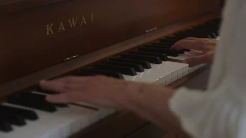 Slow motion shot view of Hands On Piano Keys playing song in room, indoors Stock Footage 208792683