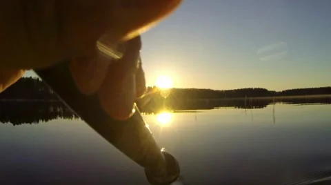 Slow motion shot of water dropping from a paddle when kayaking in the sunset Stock Footage 67989618