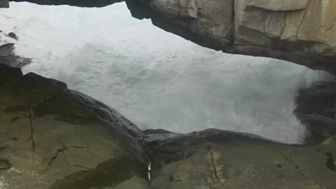 Slow Motion Shot of water going underneath the Natural Bridge Stock Footage 305524296