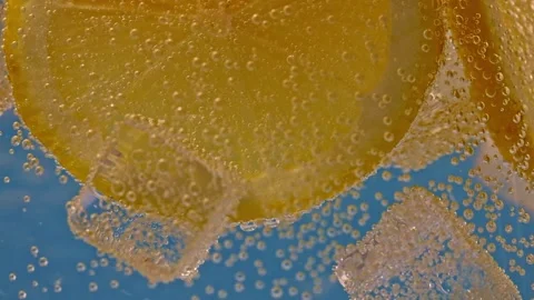Slow Motion Shot of Water Wave Splashing on Lemon Slices and Ice Cubes Stock Footage 248441434