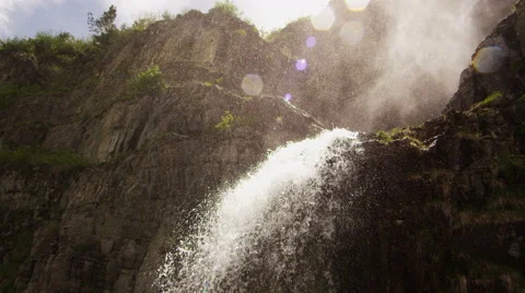 Slow motion shot of waterfall with drops of water flying through the air Video stock 52498425