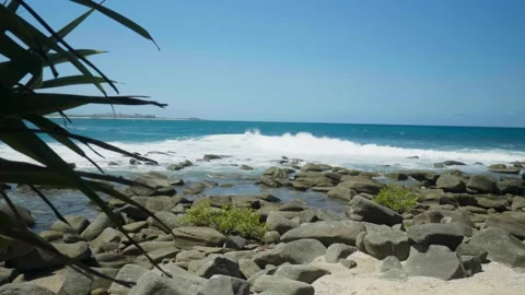 Slow Motion shot of wave breaking around a point Stock Footage 297715760