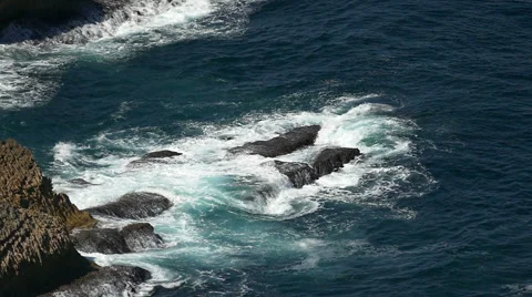 Slow Motion Shot of Waves Breaking onto Rocks Stock Footage 40935611
