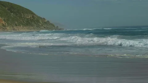 Slow Motion Shot of Waves Breaking on Isolated Beach Stock Footage 303020969