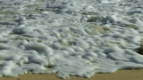 Slow Motion Shot of Waves Breaking Over Sand 動画素材 303021338