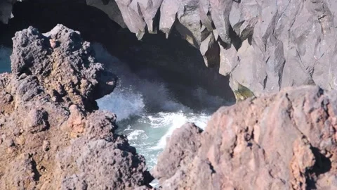 Slow-motion shot, waves hitting sea cave. Lanzarote HD Stock Footage 168346322