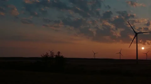 Slow Motion Shot of a Wind Farm at Sunset Stock Footage 196293937