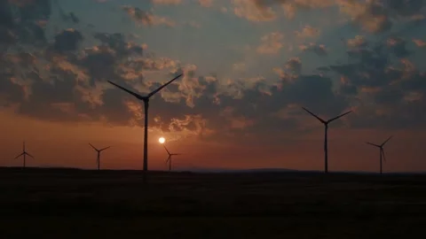Slow Motion Shot of a Wind Farm at Sunset Stock Footage 196293944