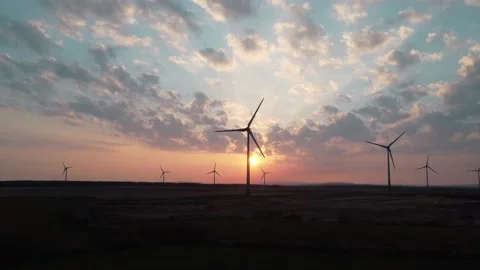 Slow Motion Shot of a Wind Farm at Sunset Stock Footage 196295805